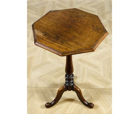 A Victorian rosewood lamp table with an octagonal shaped top and turned central column, raised upon shaped tripod legs, 43 x 