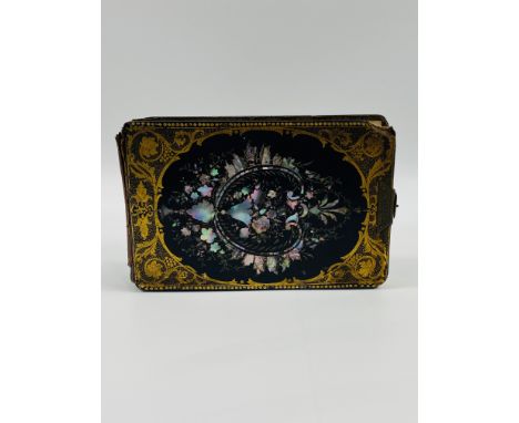 A 19th century black lacquered photograph with gilt decoration, inlaid with mother of pearl, and a brass closing clasp.23.5cm