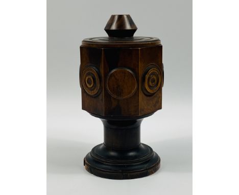 An unusual Lignum Vitae octagonal lidded vessel with turned decoration,and raised upon a circular base.inscribed to the under