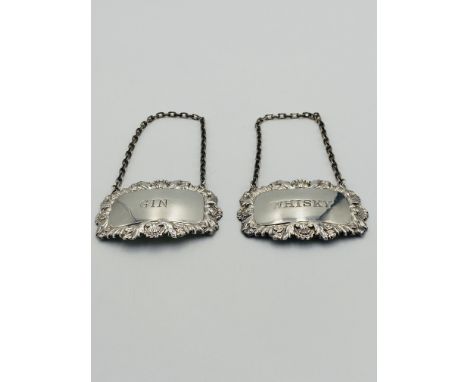Two silver hallmarked decanter labels, marked Whisky and Gin. Estimate: £20-40.This item qualifies for in-house posting.