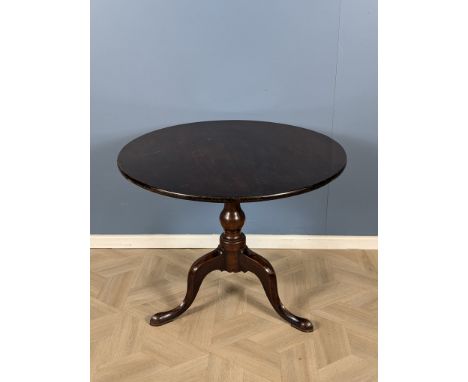 A Georgian mahogany birdcage tripod table with a baluster turned central column, and raised upon tripod legs with shaped pad 