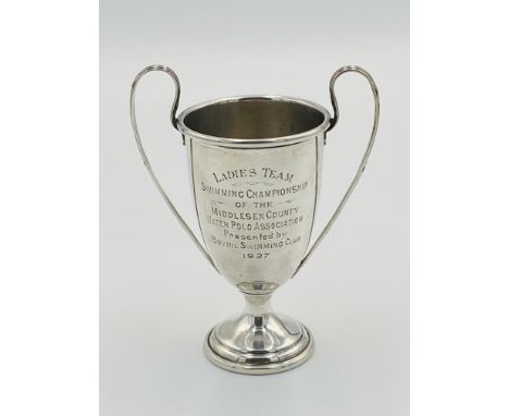 Silver trophy with engraving to front, 76g, approximately 11cm high, on wooden base, Estimate: £45-60.This item qualifies for