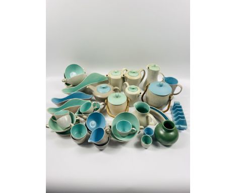 A collection of approximately 40 items of Poole pottery to include: tea pots; cups; toast rack; jugs and biscuit barrel. Esti