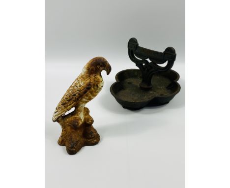 A painted cast iron door stop in the form of a bird, 20 x 15cms; together with a cast iron painted boot scraper of typical fo