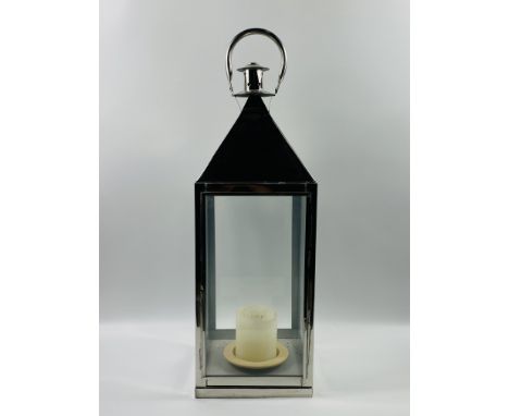 A large contemporary polished metal hanging candle lantern.25.5cms wide x 25.5cms deep x 82cms high.Estimate £20-40.