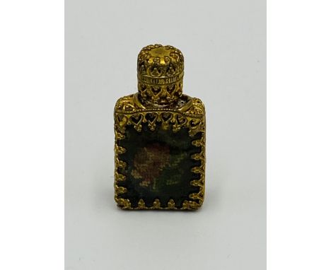 A Continental gilt metal perfume bottle with tapestry to front and glass dropper, 3cm high. Estimate: £25-50