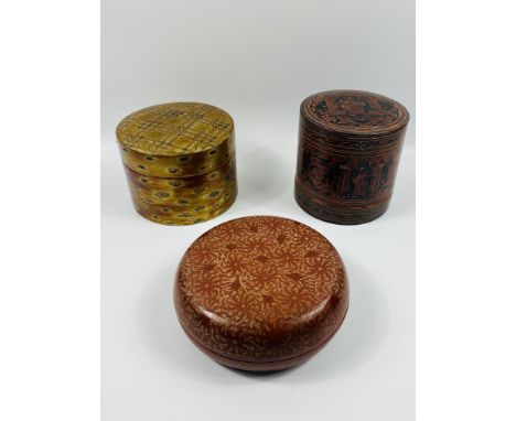 A group of three circular boxes to include: a Bidri lacquered box with lift out trays to the interior, 18 x 18cms; a Japanese