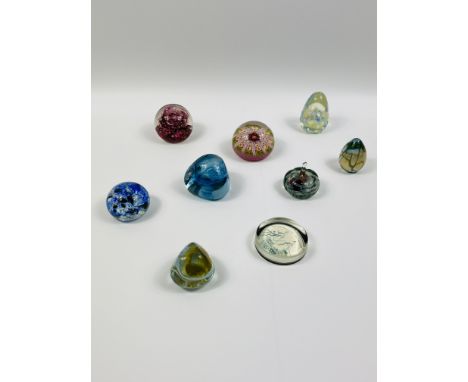 A collection of nine glass paperweights to include; Selkirk glass, Isle of Wight glass; Caithness Pebble Scotland; MTARFA Gla