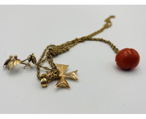 9ct gold chain, with 9ct gold cross and red pumpkin, approximately 7g. Estimate: £130-150.This item qualifies for in-house po