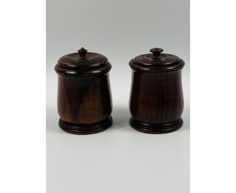 A near pair of early 20th century turned hardwood jars with covers.13.5cms high x 9.5cms base diameter. Estimate £20-30.This 