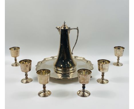 A silver plated Mappin and Webb claret jug and six goblets,complete with a shaped pie crust edge tray,All pieces stamped Mapp