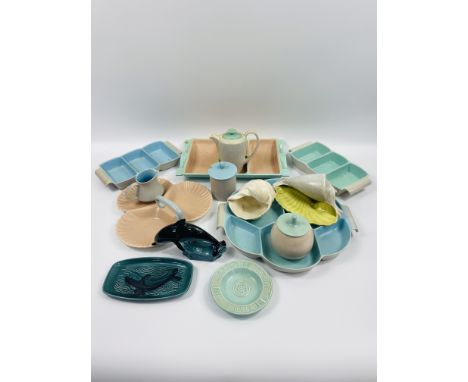 Fourteen items of Poole pottery to include a dolphin figure; nut tray; two shells and a coffee pot. Estimate £20-30.