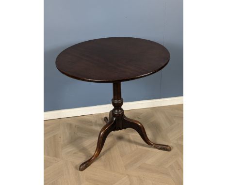 A Georgian mahogany circular tripod table,with a one piece top and turned central column, raised upon shaped tripod legs, 72 