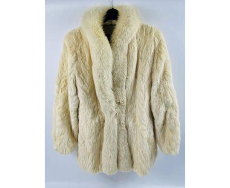 A cream coloured fur jacket with manufacturers label, Estimate: £30-50.This item qualifies for in-house posting.