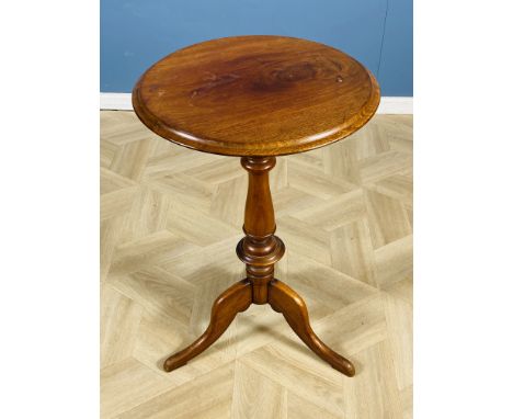 A Victorian circular mahogany wine table, with a turned central column,and raised upon shape tripod legs, 47 x 73cms high. Es