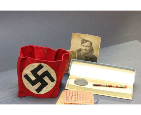 A Nazi swastika armband together with an army ribbon bar showing 1939-45 Star, Africa Star and Italy Star. Also several photo