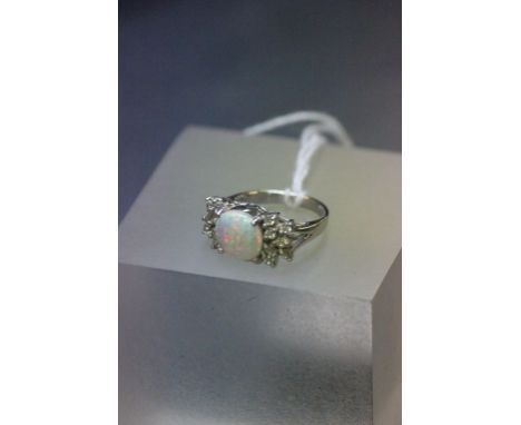 A silver opal and CZ three stone ring