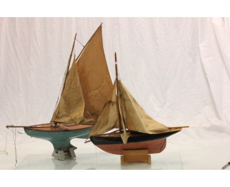 Two vintage wooden Pond Yachts with stands & sails, the larger one with an A W Gamage Holborn London brass plaque
