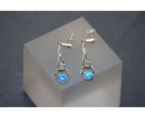 A pair of silver drop earrings set with blue opal panels