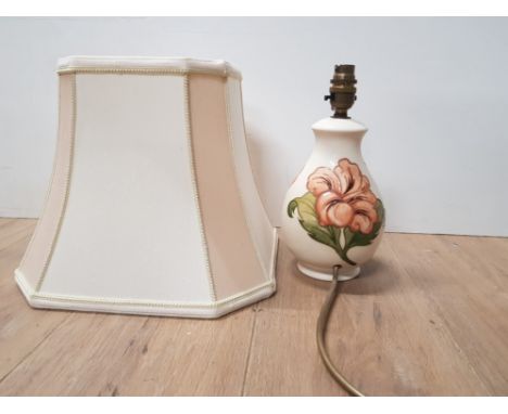 A MOORECROFT HIBISCUS TABLE LAMP ON CREAM BACKGROUND