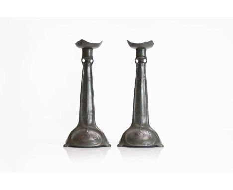 A pair of Kayserzinn cast pewter candlesticks, each with a removable drip pan, over a pierced and tapering column, cast lozen