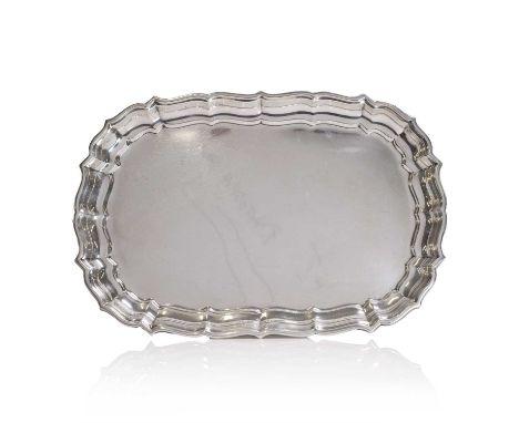 A Cartier silver 'Chippendale' tray, 20th century, of oval form with a scrolled border, stamped 'Cartier sterling' and 'Chipp