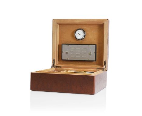 An Hermès sapele humidor, of recent manufacture, the top inset with a shagreen panel, enclosing an humidity gauge with detach