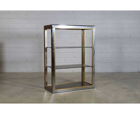 Renato Zevi (Italian, 1921-1999), a chrome and brass bookcase, c.1970, the chrome frame with brass edging, supporting three g