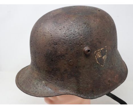 An Imperial German WWI relic steel M-16 helmet shell, displaying remnants of paint and single decal, with later liner. UK P&a