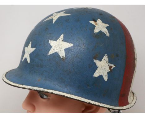 An American M-1 helmet and liner, with later memorial painting, with and camouflage cover. UK P&amp;P Group 3 (£30+VAT for th