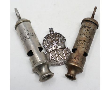 A British Home Front ARP whistle by Hudson &amp; Co, a hallmarked silver ARP buttonhole and an 1899 dated Metropolitan whistl