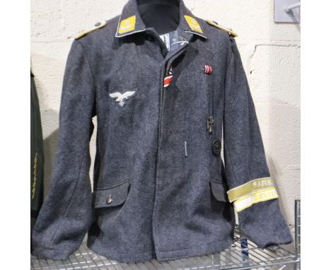 A replica German WWII Luftwaffe officers tunic, displaying ribbon bar, wound badge, Iron Cross second class, two cuff titles 