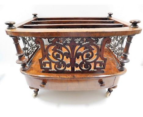 A decorative 19thC. walnut Canterbury with ceramic wheels 23in wide x 16in deep x 18in high. Provenance: From Grade II Listed