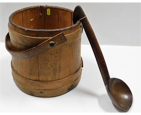 A wooden coopered bucket twinned with a 19thC. treen soup ladle