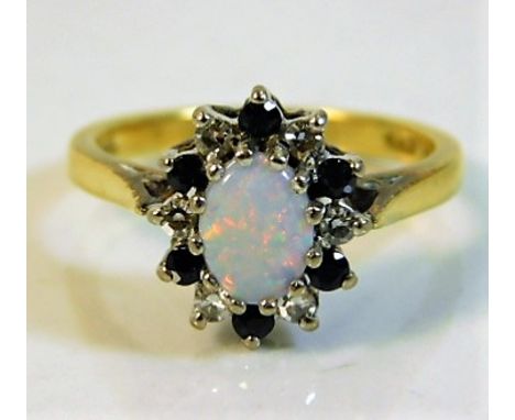 An 18ct gold ring set with diamond, sapphire &amp; opal 3.9g size K/L