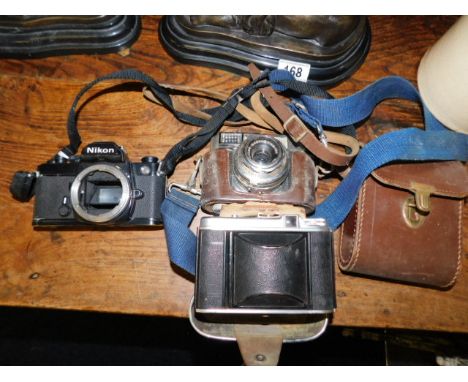 A Voigtlander camera, a Niko camera body &amp; one other camera 