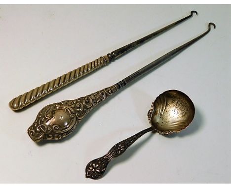 Two silver handled implements twinned with a decorative silver caddy spoon 