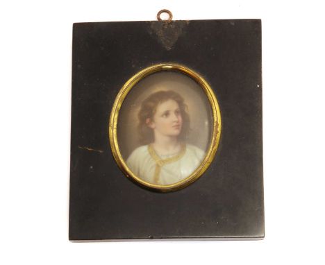 A portrait miniature on porcelain,19th century, depicting a youth possibly Christ, in a glazed ebonised frame, 9cm x 7cm
