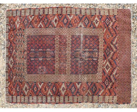 A hand knotted Turkmen flatweave rug,c.1900, the brick red fields with geometric centre within alternating repeated diamond m