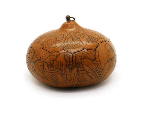 A 19th century carved wood gourd,the lidded fruit with brass ring handle, carved with Napoleon to overall leaf decoration16cm