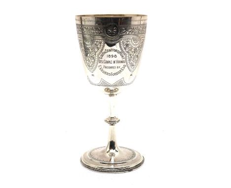 A Victorian silver hunting trophy cupBirmingham, 1897 or 1898, the bowl raised on a knopped stem and circular spreading foot,