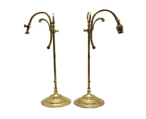 A pair of adjustable brass table lamps,early to mid-20th century, each with a scrolled arm above a stepped base,45cm high (2)