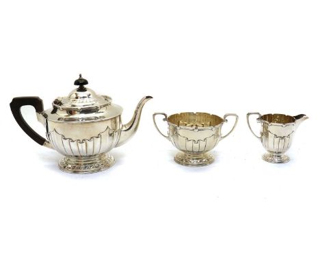 A silver three piece tea service,by Harrison Brothers &amp; Howson, London 1906, comprising a teapot, 16cm high a sugar bowl,