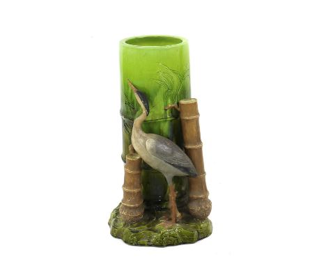 A majolica pottery stick stand, probably by Bretby, late 19th century, in the form of a heron amongst bamboo,30cm diameter60c