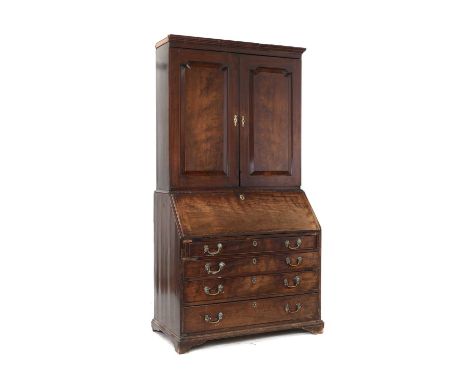 A George II mahogany bureau bookcase, the moulded cross grain cornice above pair of panel doors above full front waterfall in