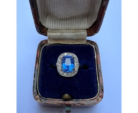A 3.03 carat natural Sri-Lankan sapphire &amp; diamond cluster ring, the rectangular cushion cut sapphire in raised claw sett