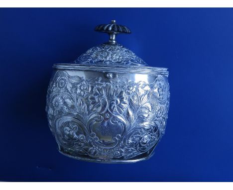 A Regency embossed silver oval tea caddy with ebony finial , decorated shells &amp; flowers, two internal compartments - Will