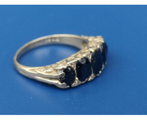 A five stone graduated sapphire ring on 18ct shank.  Finger size K.