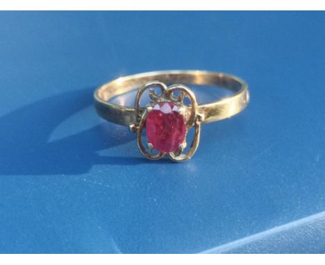 A certified natural ruby solitaire ring, the oval cut stone in four-claw setting on yellow 14K shank, accompanied by a Gem &a