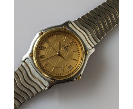An Ebel Classic Sports Wave wristwatch with gold face, Roman numerals, date aperture, sweeping seconds hand, case 34mm, 18ct 